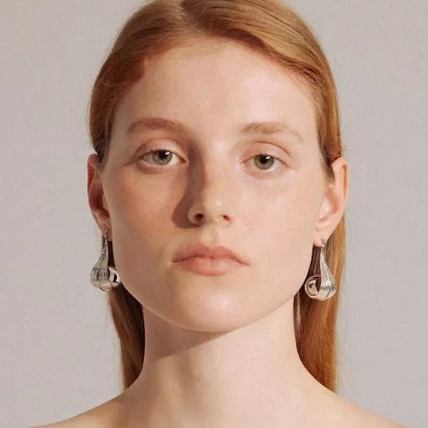 Modern silver curved leaf earrings