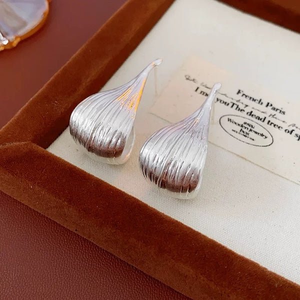 Modern silver curved leaf earrings